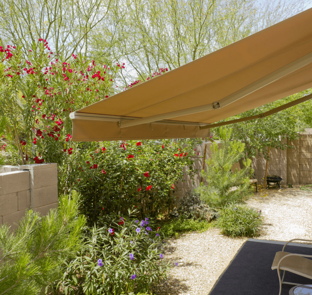 Patio with awning and garden view.