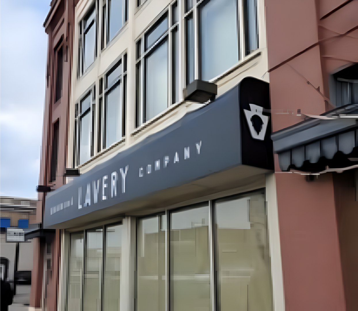Exterior view of a bakery company storefront with signage.
