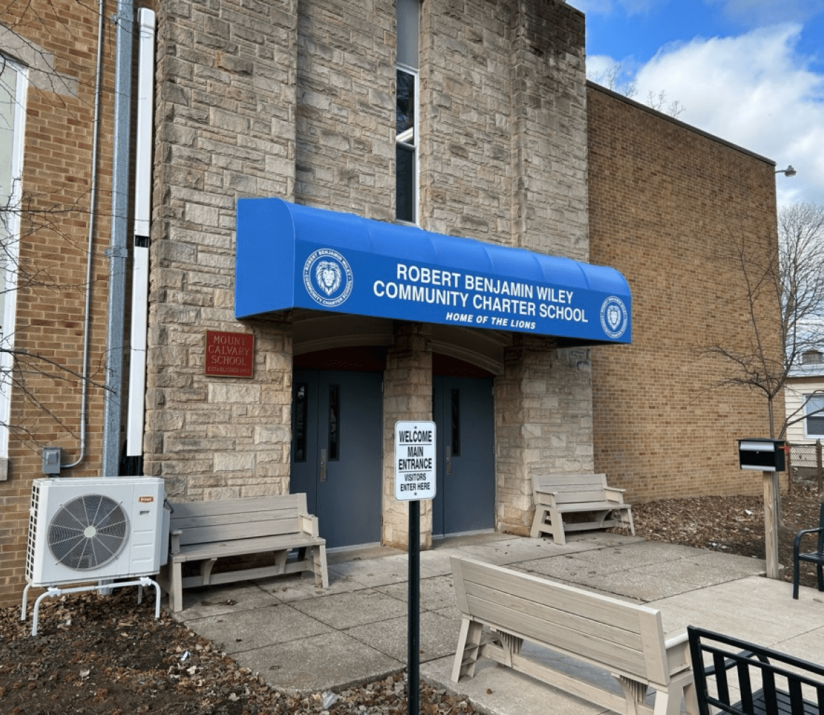 Entrance of Robert E. Lee High School with blue canopy and sign.